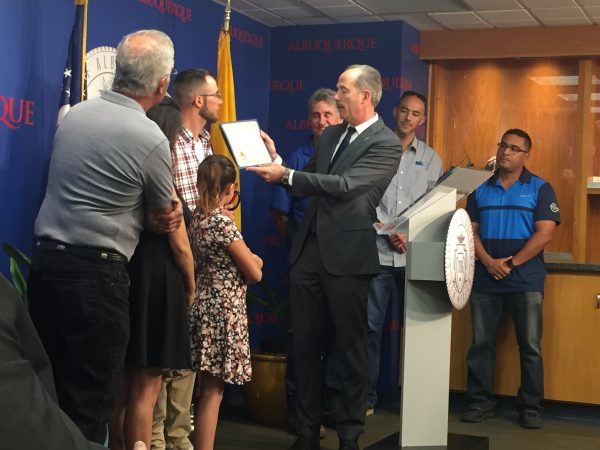 Photo of Mayor Richard Berry presenting Good Samaritan Award to Anthony Deluca.